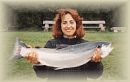Woman with fish near fly fishing lodge and outdoor activities near puerto montt, chile